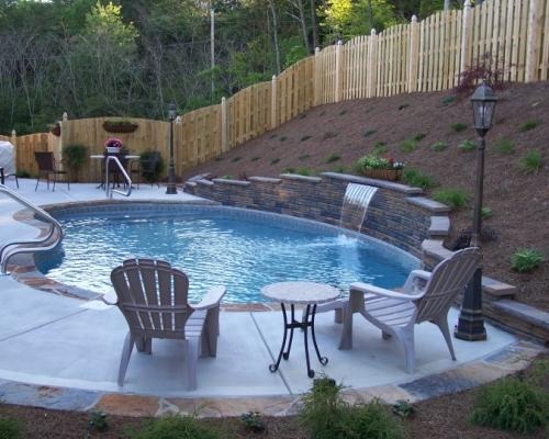 pool with waterfall in backyard